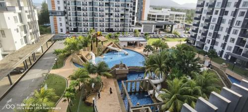 an aerial view of a pool at a resort at Pool view + water theme park @swiss garden residence in Kuantan