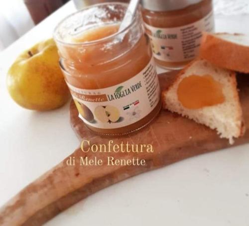 a plate of food with peanut butter and jam and fruit at B&B La Foglia Verde in Massa