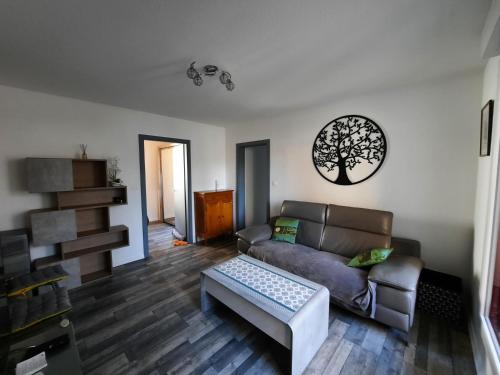 a living room with a couch and a table at F2 Rénové Centre de Haguenau in Haguenau