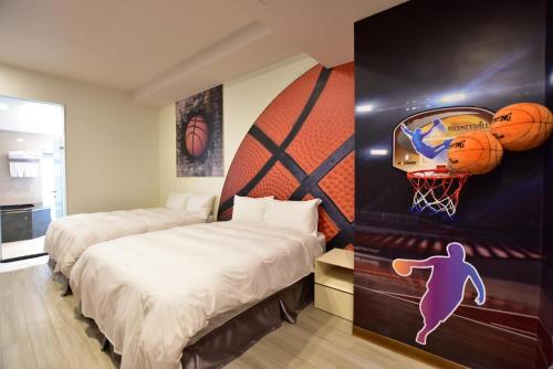 a bedroom with two beds and a basketball mural at Muen Yuan Dong Hot Spring Hotel in Jiaoxi