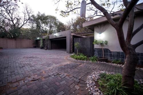 a brick driveway in front of a house at Cottonwood Guesthouse Oasis in Bloemfontein