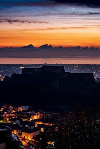 a view of a city at night with a mountain at B&B La Foglia Verde in Massa