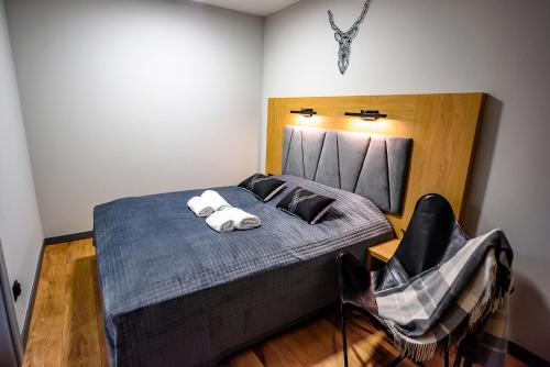 a bedroom with a bed with two towels on it at Wójcik SPA - Krynica Zdrój in Krynica Zdrój