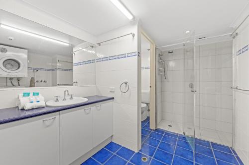 a bathroom with a sink and a shower at Northwind Beachfront Apartments in Mooloolaba