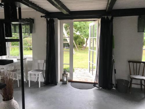 a living room with a sliding glass door at Stallet på Skårby in Ystad