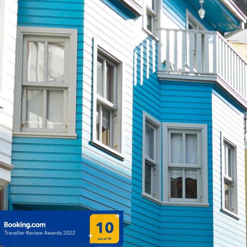 a blue and white building with two windows at Tilas - Rooms in 19th Century Wooden Townhouse,Kadikoy in Istanbul
