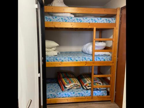 a wooden bunk bed with towels and pillows on it at Les Rousses in Oz