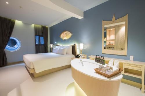 a hotel room with a bed and a sink at Beyond Patong in Patong Beach