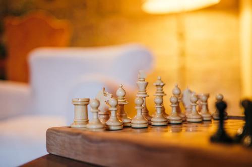 a chess set on a wooden chess board at Convento San Bartolomeo in Abbadia San Salvatore