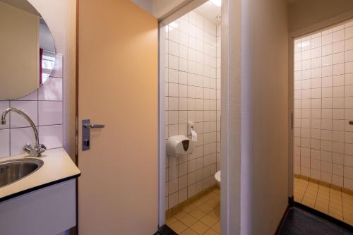 a bathroom with a sink and a toilet at Stayokay Hostel Arnhem in Arnhem