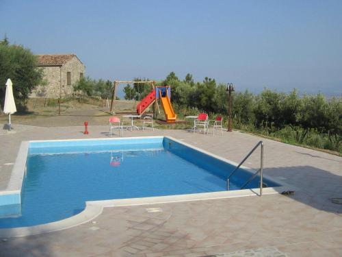 a swimming pool with a slide and a playground at Agriturismo San Fele in Cerchiara di Calabria