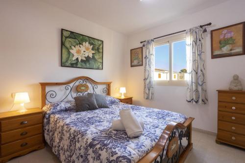 a bedroom with a bed with two pillows on it at Villa Playera in Alcudia