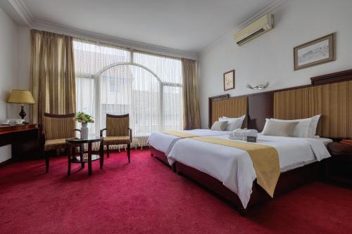 เตียงในห้องที่ Garni Hotel Planeta Inn