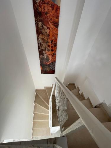 a staircase with a painting on the wall at BELKA GOLF RESİDENCE Deluxe apt Poolside BELEK in Belek