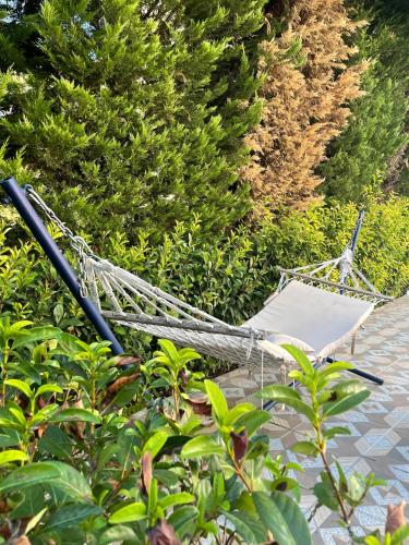 a hammock laying on the ground next to some bushes at BELKA GOLF RESİDENCE Deluxe apt Poolside BELEK in Belek