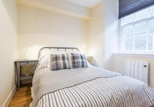 a bedroom with a bed and a window at Number 70 in Haddington