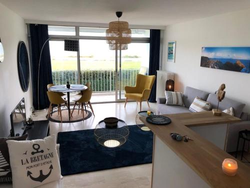 een woonkamer met een bank en een tafel bij Résidence des 3 iles in Quiberon