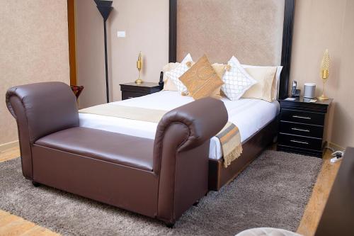 a bed and a chair in a room at Masawara Urban Retreat in Harare