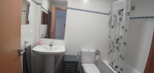 a white bathroom with a sink and a toilet at Super appartement à 200m de la plage à « Portisel » in El Verger