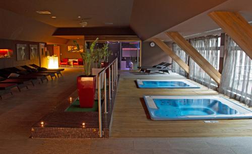 two hot tubs in the middle of a hotel room at Holiday Inn Trnava by IHG in Trnava