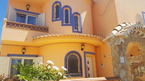 a house with blue and orange paint on it at Lagos Room Booking in Lagos