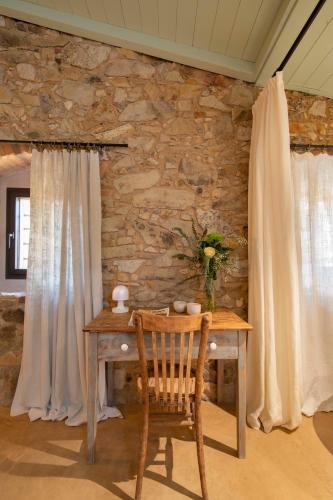 a wooden table with a vase of flowers on it at Mas Rauric in Llagostera