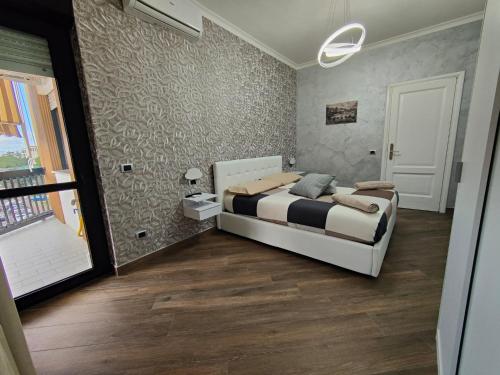 a bedroom with a bed in a room with a window at B&B MaisonAlysie in Foggia