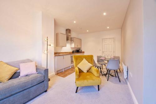 a living room with a couch and a dining room at Wearmouth boutique apartment in Sunderland