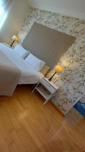 a bedroom with a large bed and a rug at Martin Gamero Apartments in Toledo