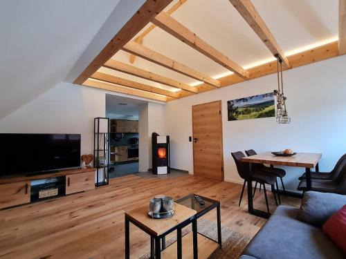 a living room with a couch and a table at Ferienwohnung Zur Rhön Tischlerei in Wiesenthal