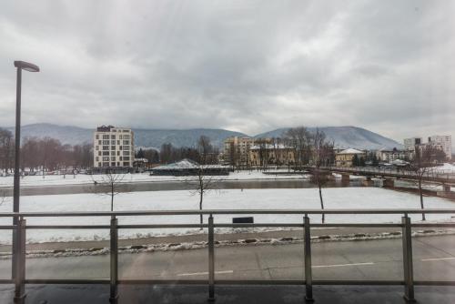 a view of a city with a snow covered field at VIP Apartments in Sarajevo