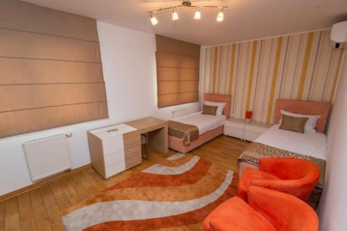 a room with a bed and a desk and a chair at VIP Apartments in Sarajevo