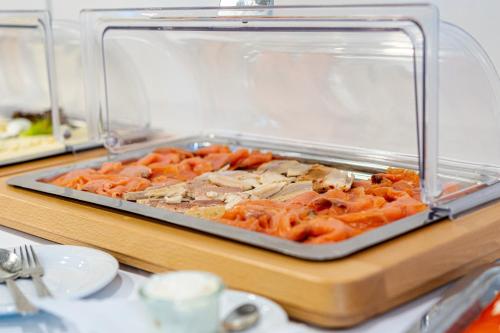 a tray of food on a buffet table at Hotel Restaurant Kloppendiek in Vreden
