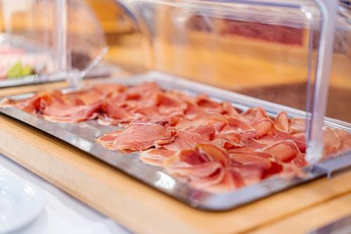 a tray filled with meat on a table at Hotel Restaurant Kloppendiek in Vreden