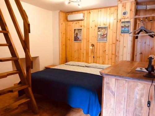 a bedroom with a bed and a wooden wall at CASA VACANZE NORA in Chamois