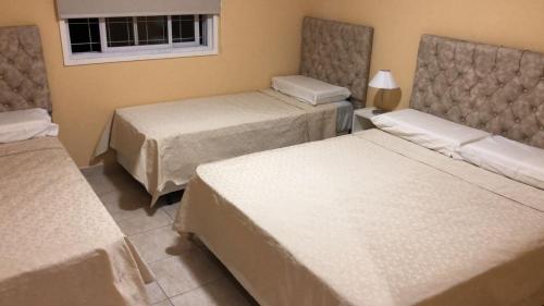a hotel room with two beds and a window at Sol Latino 2 in Victorica