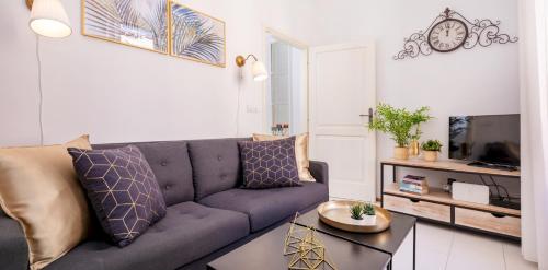 a living room with a couch and a tv at Stradun Residence in Dubrovnik