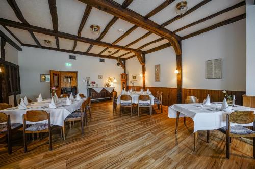 a dining room with white tables and chairs at Hotel Restaurant Kloppendiek in Vreden