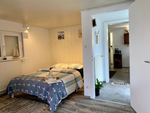 a bedroom with a bed with a table in it at Le Pi'style(chambre,cuisine,salle d’eau,terrasse) in Ingwiller
