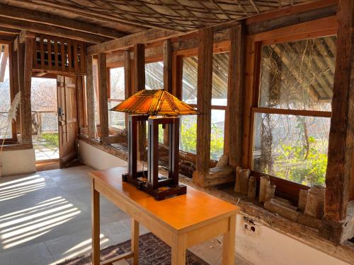 a lamp on a table in a room with windows at Gulevi Safranbolu in Safranbolu