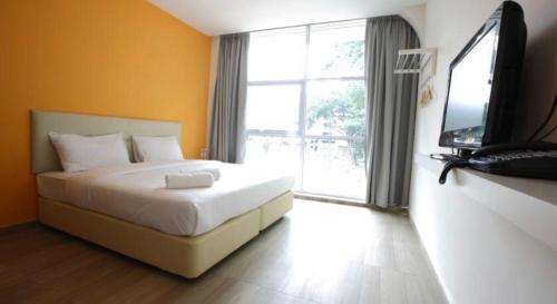 a bedroom with a bed and a television in it at City Kuchai Hotel -Kuchai Lama,Kuala Lumpur in Kuala Lumpur