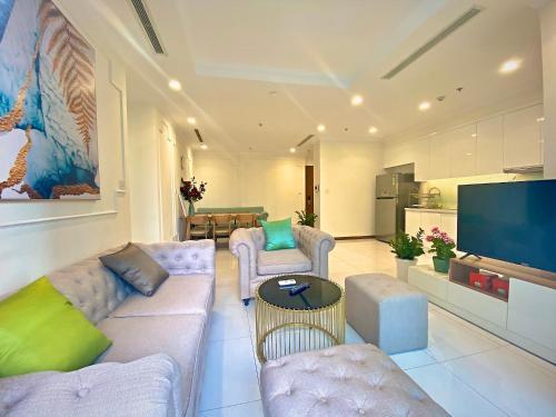 a living room with couches and a flat screen tv at Central Apartments - Vinhomes Central Park, Landmark 81 Area & Ice Skating Rink in Ho Chi Minh City