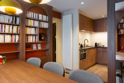 a kitchen and dining room with a table and chairs at RockyPop Flaine Hotel & Spa in Flaine