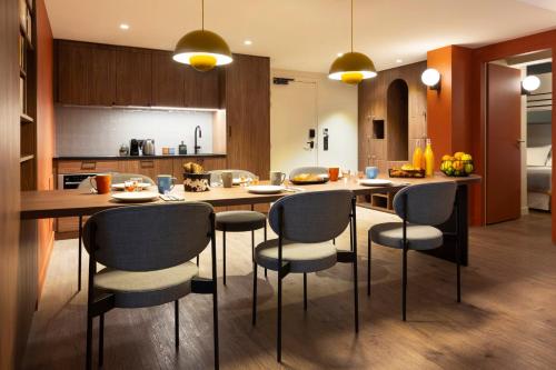 a kitchen with a large wooden table and chairs at RockyPop Flaine Hotel & Spa in Flaine