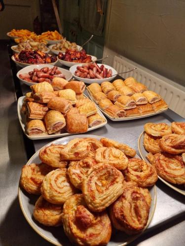 a buffet filled with different types of pastries and pies at Slaters Country Inn in Whitmore