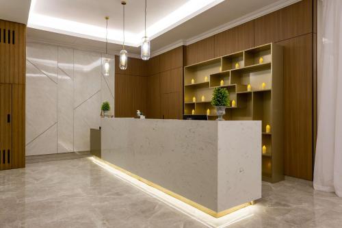a lobby with a reception desk in a building at Radisson Hotel Riyadh Airport in Riyadh