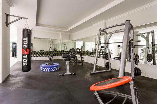 a fitness room with a gym with a punching bag at Radisson Hotel Riyadh Airport in Riyadh