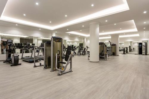 a gym with treadmills and cardio equipment in a building at Radisson Hotel Riyadh Airport in Riyadh