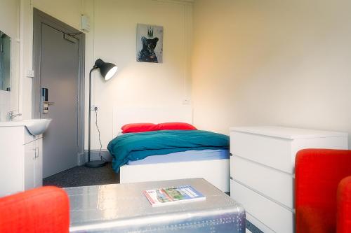 a small room with a bed and a table at Princes Street Hostel in Edinburgh