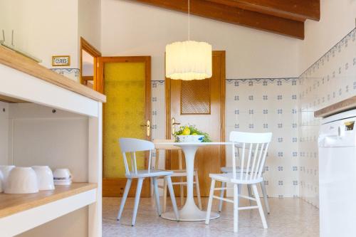 a kitchen with a table and chairs in a room at Villa Sa Tanca in Campos
